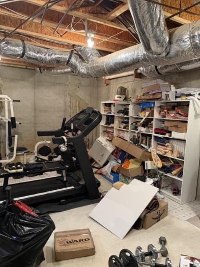 Basement storage area full of boxes and equipment before an OnCall cleanout